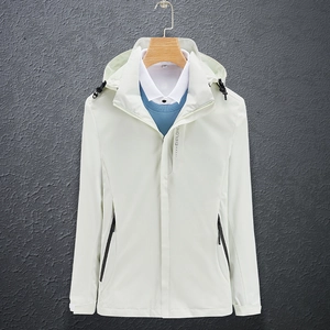 Detail of light green outdoor hooded jacket featuring zip pockets and adjustable cuffs