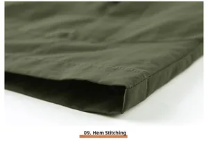 Detail shot of army green outdoor vest showing professional double-row hemline stitching