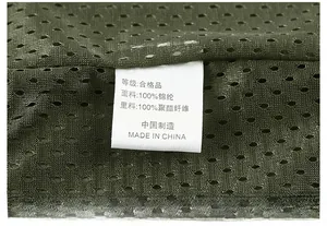 Close-up of internal wash label on army green mesh vest showing 100% nylon material