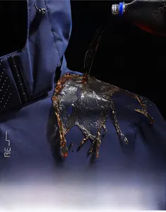 Detail of hydrophobic technology on navy outdoor jacket with Explore lettering
