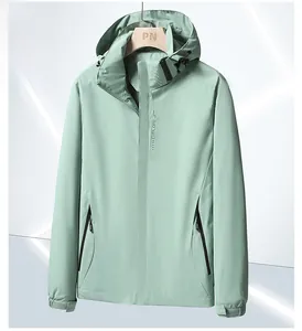 Detail of pea green outdoor waterproof jacket featuring hood and EXPLORE print logo