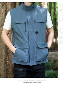 Detail of grey-blue multi-pocket outdoor vest with zipper pockets and D-ring hooks