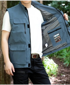 Detail of the gray-blue outdoor vest showing breathable mesh lining and inner zip pocket