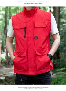 Detail of red outdoor utility vest with large flap pockets and a D-ring connector hook