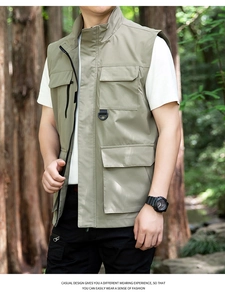 Close-up of olive green outdoor utility vest with functional multi-pockets and hanging loops