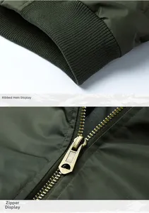 Detail view of military green bomber jacket featuring ribbed hem and bronze metal zipper