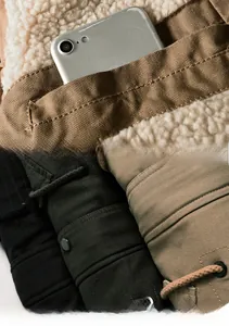 Detail showing the inner fleece lining pocket and multiple colors of the winter jacket