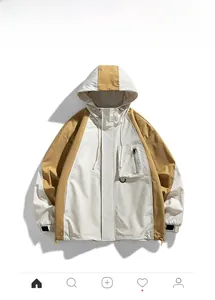 Detail of hooded windbreaker featuring color-block design and functional zipper pocket