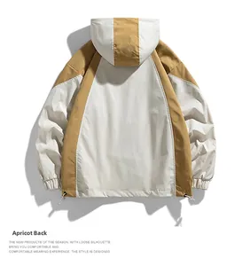 Detail view of hooded jacket back featuring beige and khaki patchwork and adjustable hem