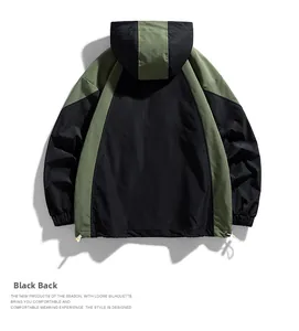Detail view of the back of a hooded windbreaker jacket with black and olive green panels