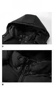 Detailed macro view of black hooded vest showing metallic zipper ring and windproof snap buttons