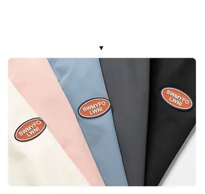 Detail of multi-color hooded sweatshirts with oval brand patch and soft knit texture