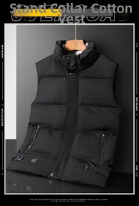 Detail view of men's black quilted puffer vest with stand collar and zip pockets