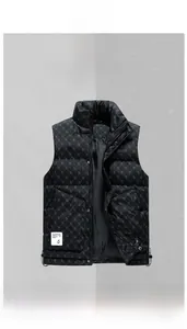 Detail view of black quilted puffer vest showing monogram pattern and water repellent fabric