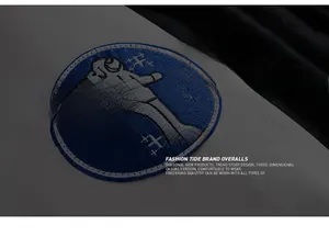 Close-up of a blue and white embroidered astronaut badge on a stylish men's casual jacket