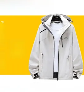 Detail of light grey outdoor windbreaker showing mountain logo and WEI-TEX sleeve cuffs