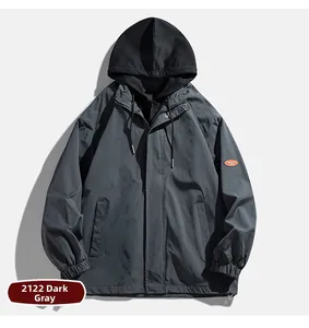 Detail of dark grey hooded jacket with orange logo patch on sleeve and ribbed cuffs
