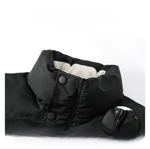 Detail of the high stand collar with dual snap button and zipper closure on black vest