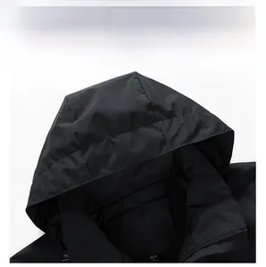 Close-up of windproof hood and neckline detail on a black outdoor jacket with zipper