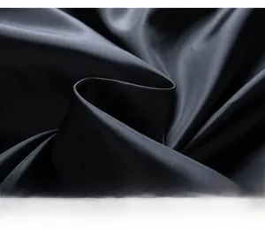 Macro texture view of dark woven fabric showing premium smooth finish and subtle luster