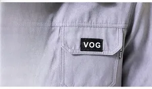 Dettaglio giacca scamosciata lilla con tasca sul petto, etichetta VOG e toppa Jeans