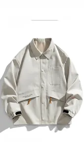 Detail of off-white utility jacket featuring snap buttons and brown drawstring pockets