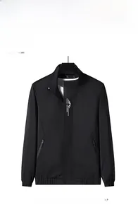 Close-up of black stand-collar sports jacket with white mountain logo and zipper pocket