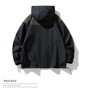 Détail du dos de la veste coupe-vent avec panneaux noir et olive et ourlet ajustable