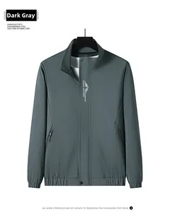 Detail of men's dark gray casual stand collar jacket with mountain logo and ribbed cuffs