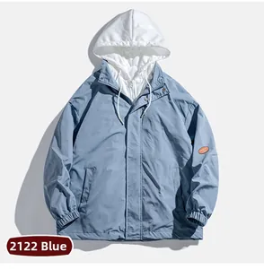 Detail of blue men's casual jacket featuring orange round sleeve badge and elastic cuffs