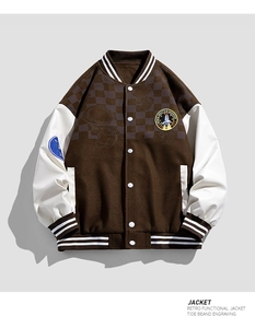 Macro shot of retro color-block baseball jacket with astronaut embroidery and ribbed cuffs