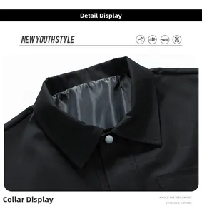 Close-up of black jacket collar with fine twill texture and light grey snap button