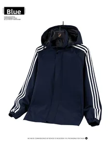 Close-up of windproof fabric jacket with white stripes on sleeves and drawstring hood