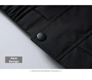 Detail shot of black quilted jacket hem with elastic cuff and matte snap button