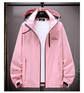 Detail of pink waterproof hooded jacket featuring adjustable drawstrings and functional pockets