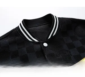 Close-up of striped varsity collar and checkerboard textured fabric with embroidery