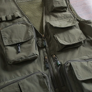 Detail of army green tactical vest featuring functional 3D pockets and breathable mesh lining