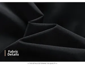 Detailed close-up of premium black woven fabric texture with smooth drape and soft folds
