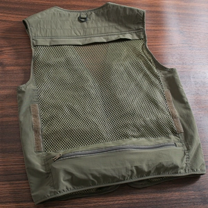 Detail of army green outdoor vest showing breathable mesh back and tactical D-ring hook