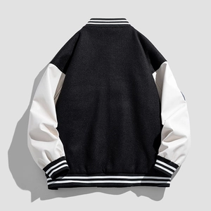 Classic black and white varsity jacket with striped ribbing, back view on grey background