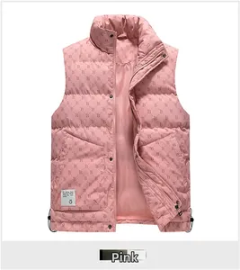 Detail of pink quilted puffer vest featuring monogram B pattern and a smiley face patch