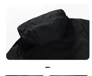 Rear view of outdoor windbreaker jacket showing matte black fabric and clean hood design