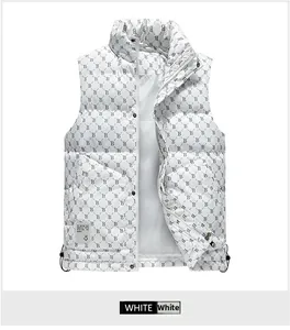 Detail of white puffer vest with monogram pattern, stand collar, and drawstring hem