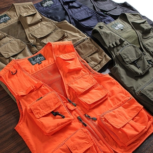 Detailed stack of multi-pocket tactical vests in various colors on a dark wood background