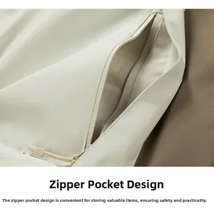 Detail der cremeweißen Outdoor-Jacke mit verdeckter Reißverschlusstasche und Kordelzug