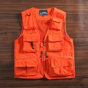 Detail of bright orange tactical vest featuring multiple utility pockets and breathable mesh