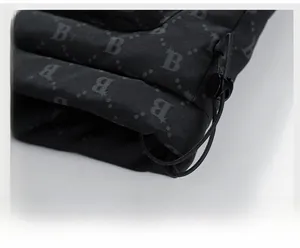 Close-up of winter vest hem featuring adjustable elastic drawstring and letter pattern fabric