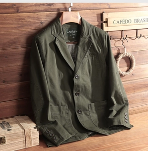Detail of olive green casual cotton blazer with elbow patches and stripe lining