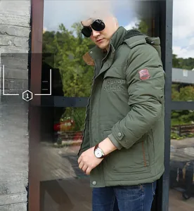 Close-up of military green winter parka with warm fleece lining and windproof cuffs