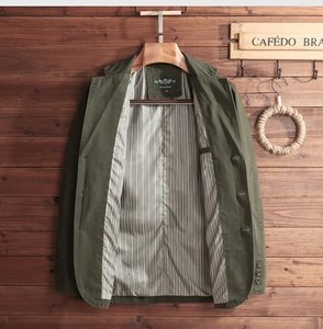 Close-up of olive casual blazer with striped lining and branded neck label detail